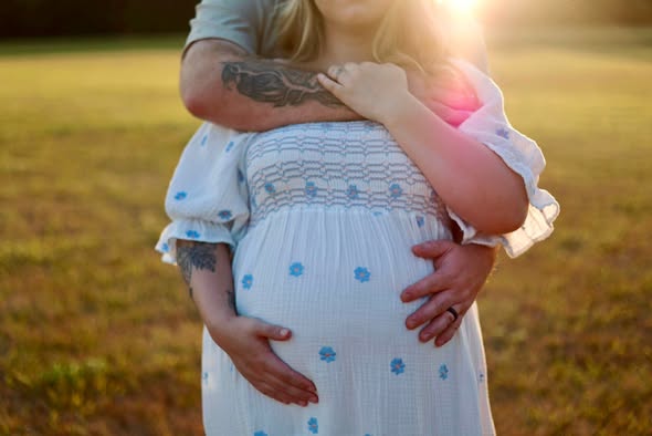Expecting couple during a warm sunset maternity photography session